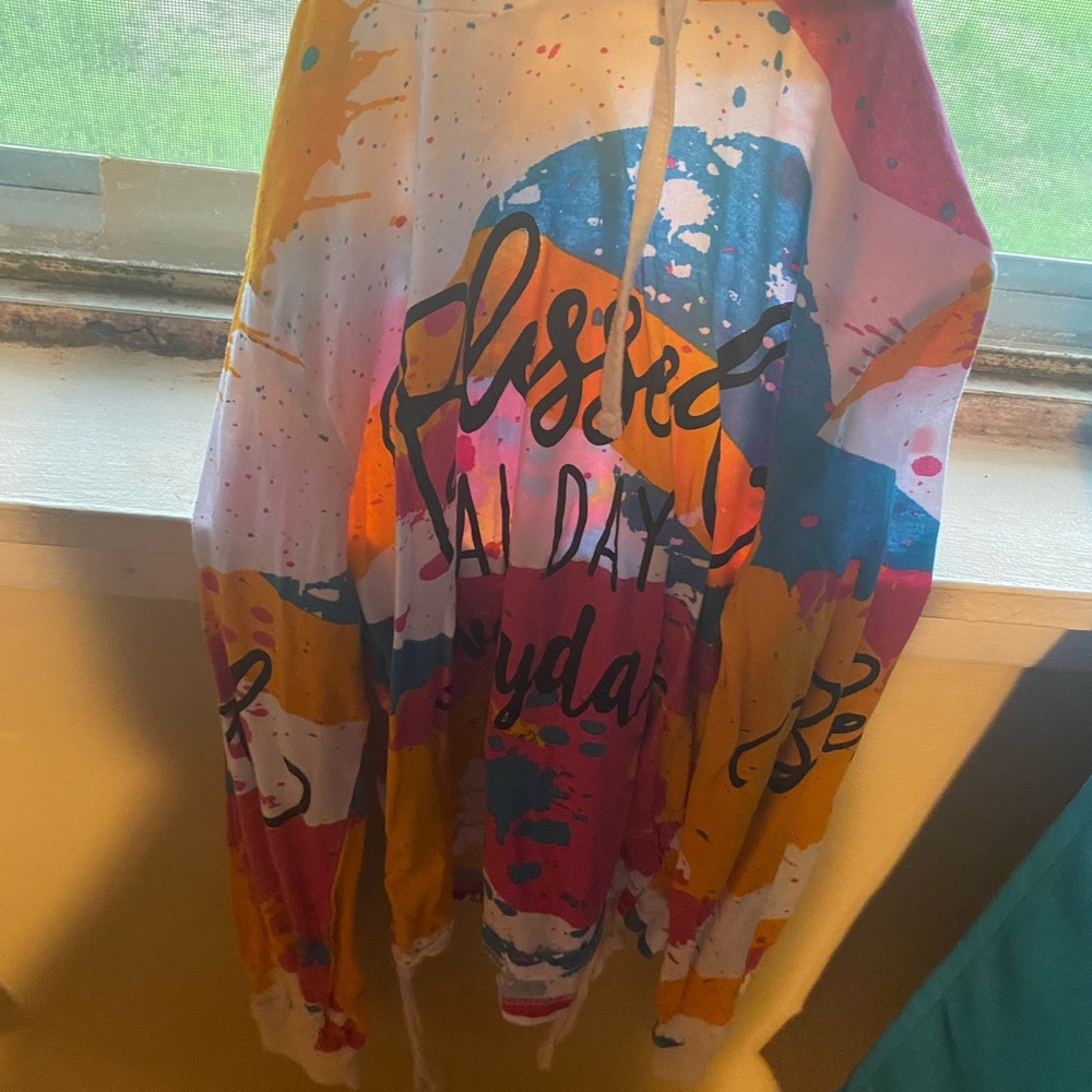 This is a thin sweater with a hood, it is a beautiful pop of so many colors.